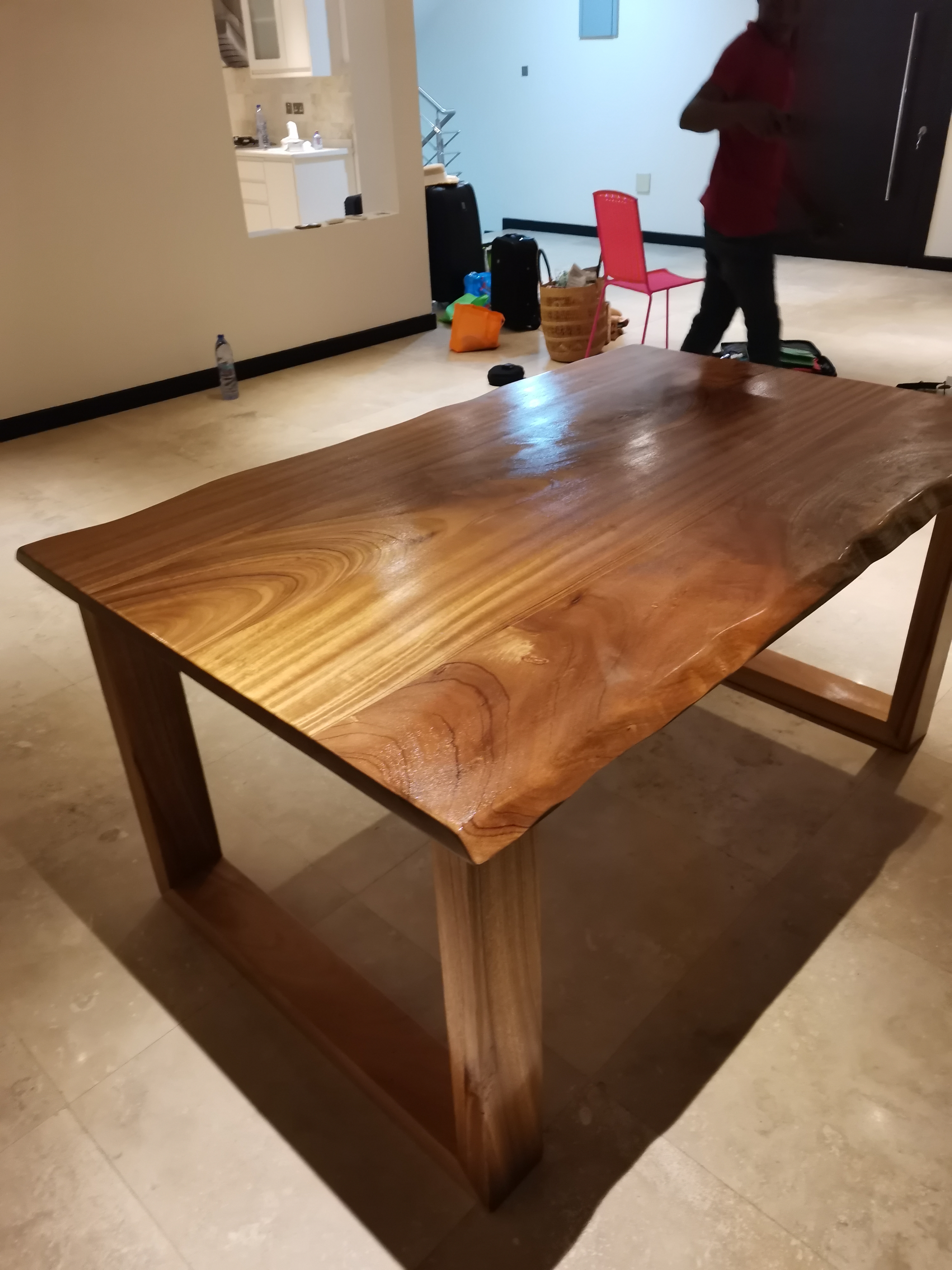 Afromosia live-edge dining table with U-frame legs, Ridge, Accra — built by Neewoody Custom Woodwork