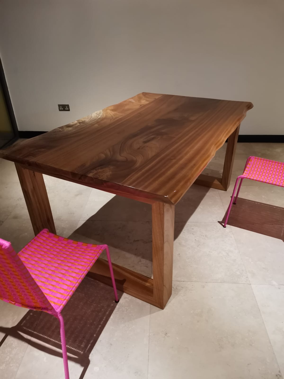 Afromosia live-edge dining table installed — daytime view