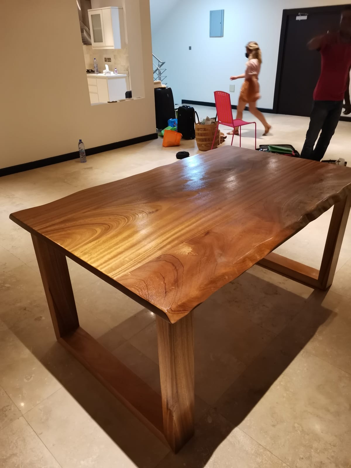 Afromosia live-edge dining table — top view showing the grain