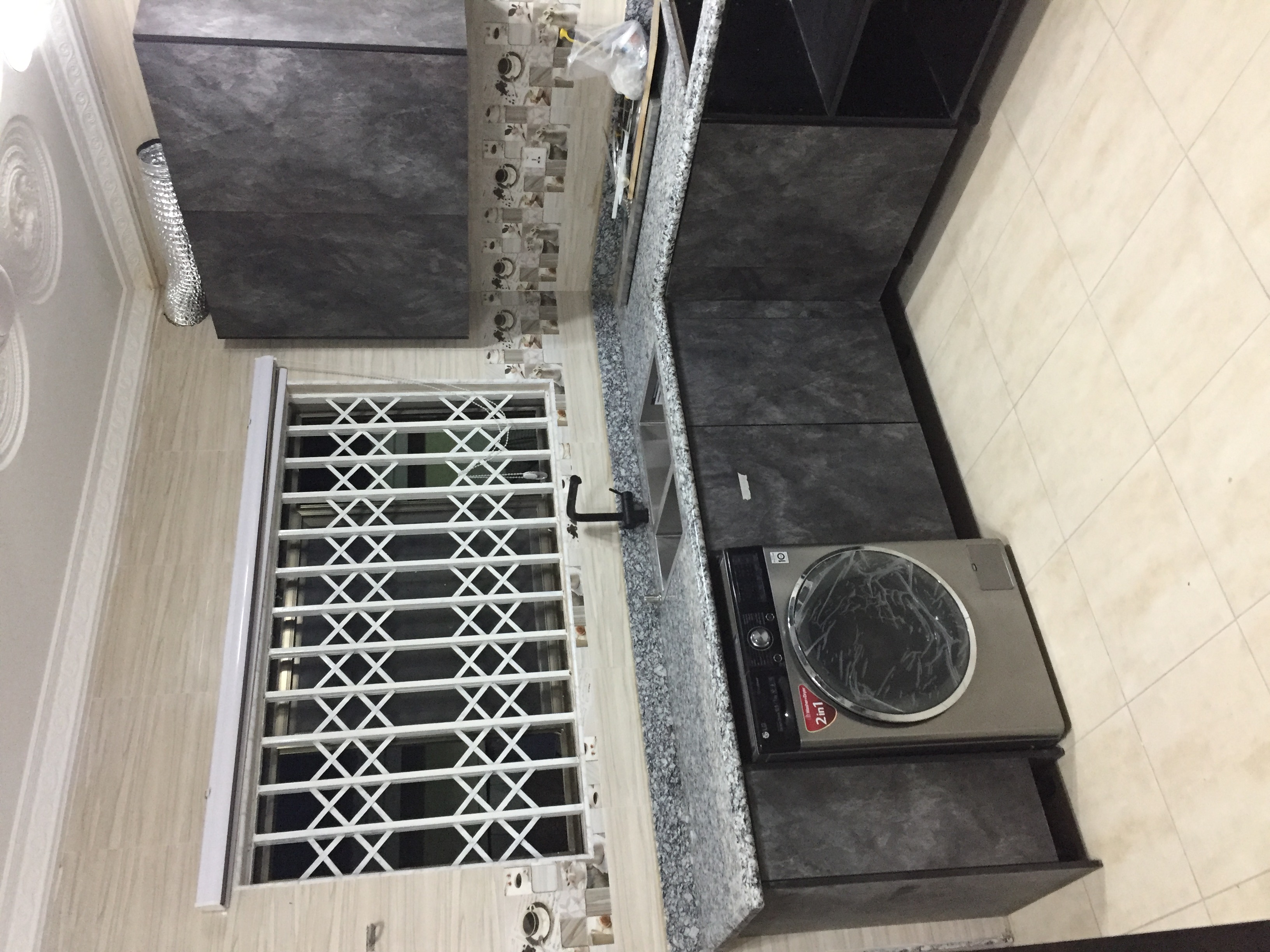 Dark charcoal concrete-effect kitchen with granite countertops — Kukurantumi, Eastern Region