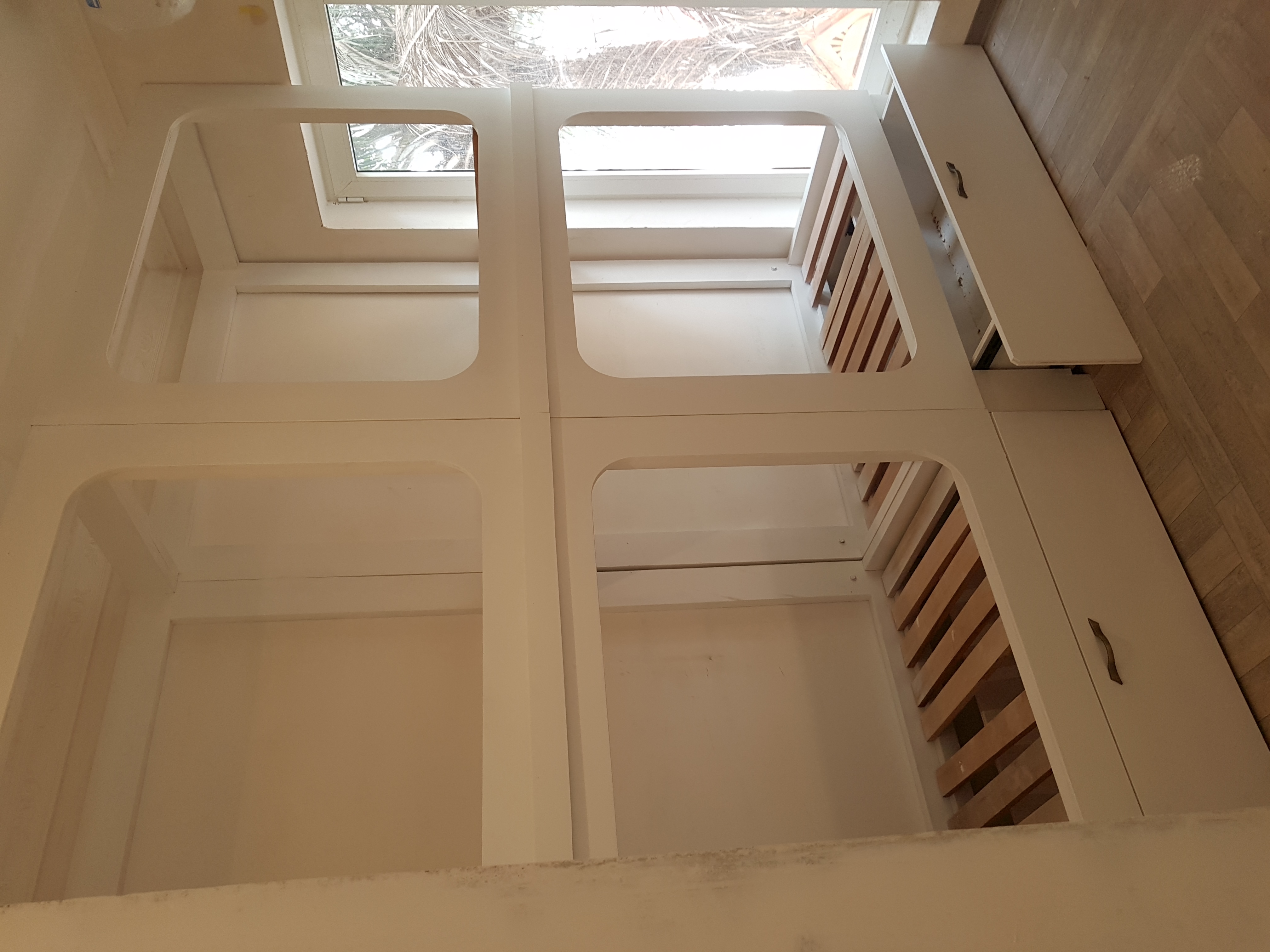 Custom 4-pod bunk unit with arched entries and under-bed drawers, built for a Montessori school, Accra