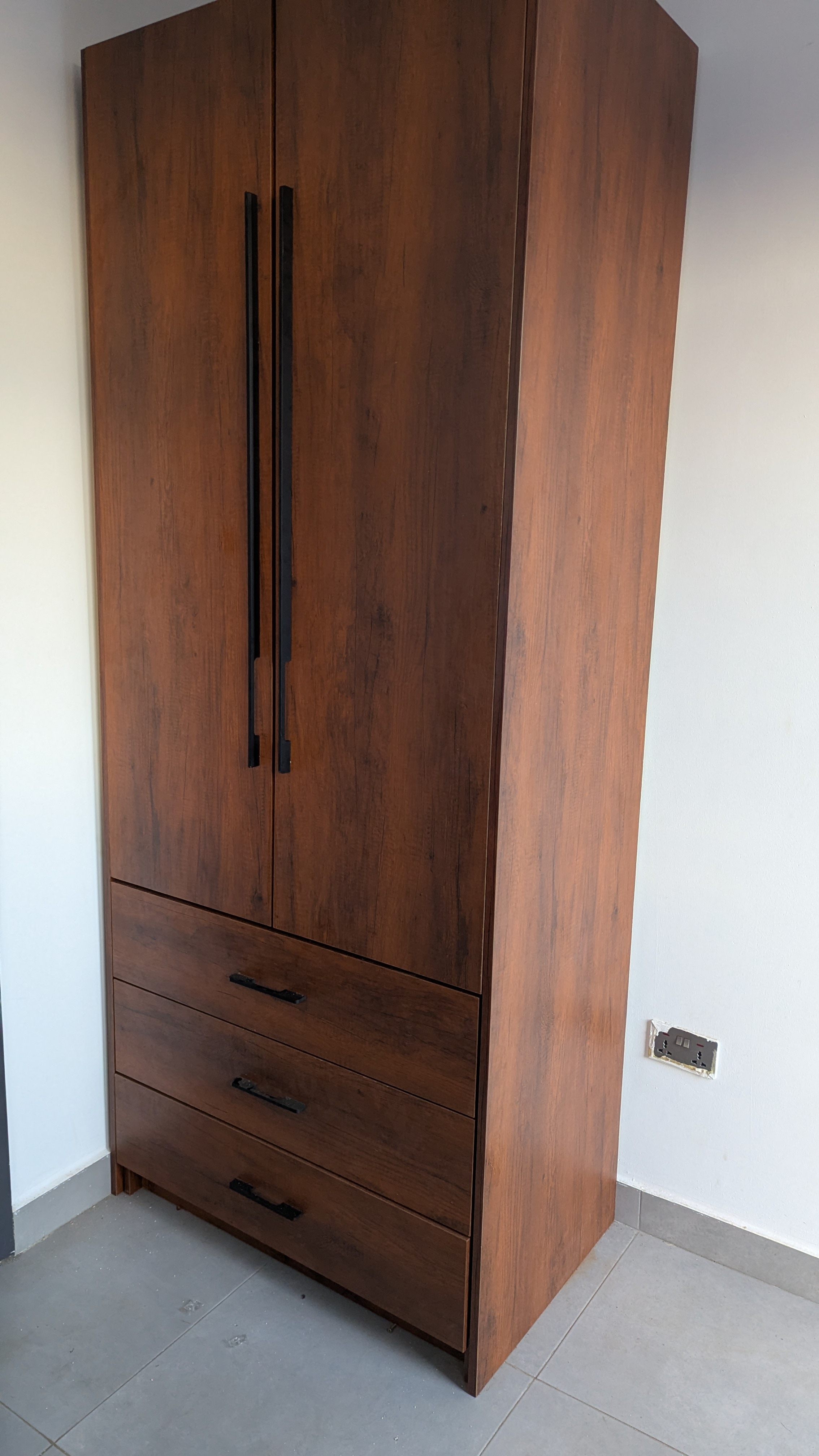Full-height fitted wardrobe in dark laminate — angled view