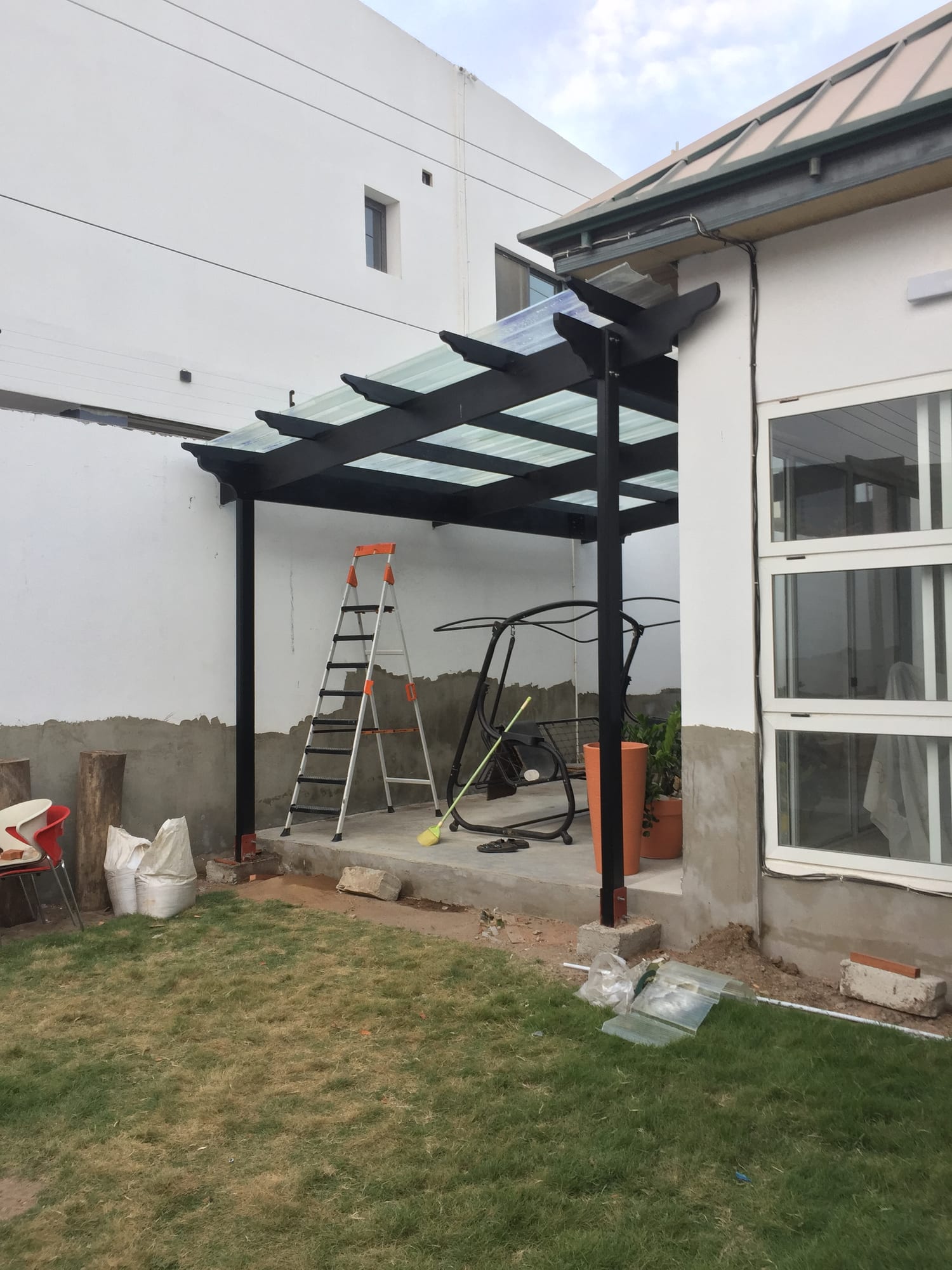Timber pergola over a patio, Accra