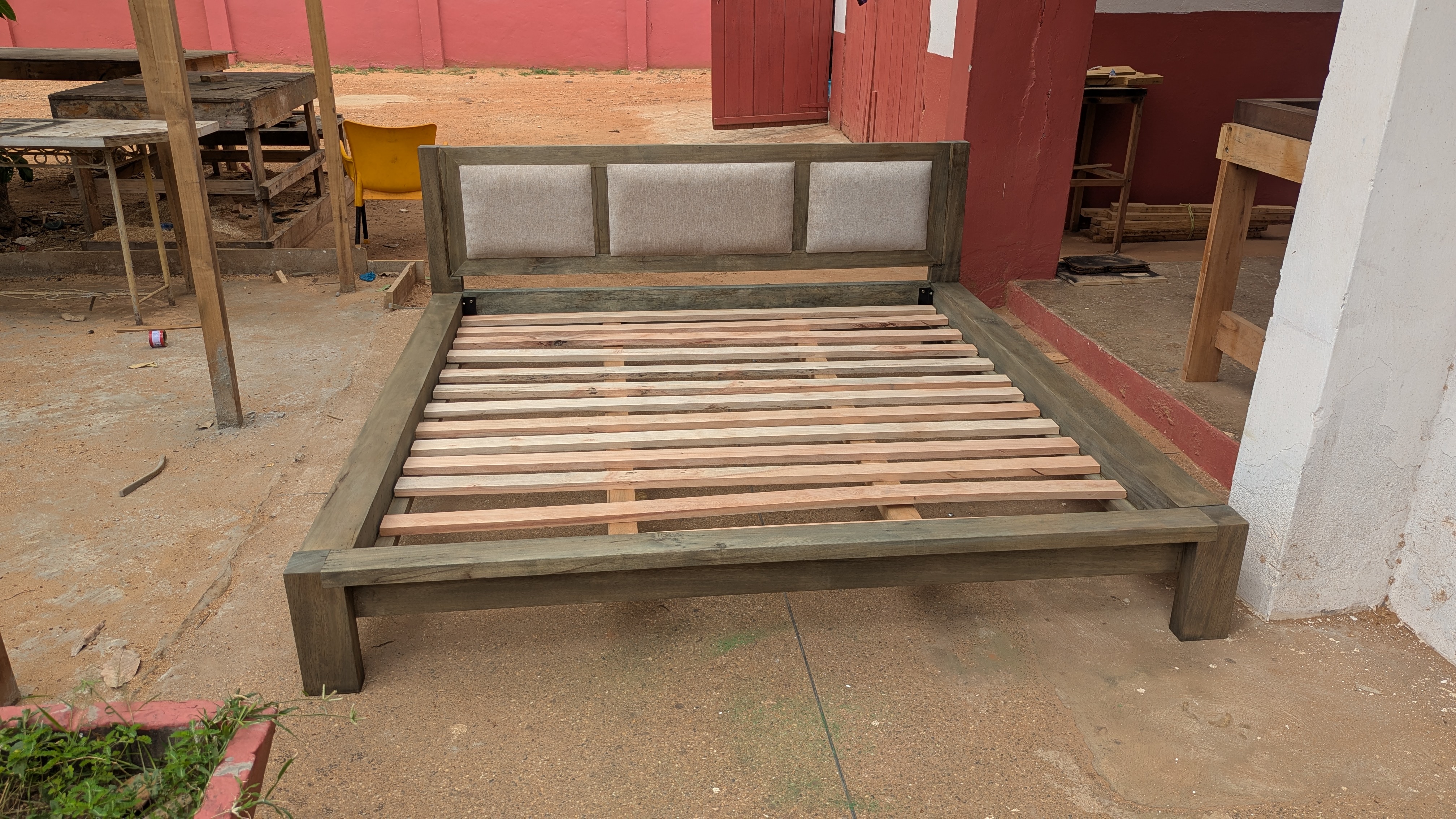 Custom platform bed in grey weathered finish with linen upholstered headboard, Accra