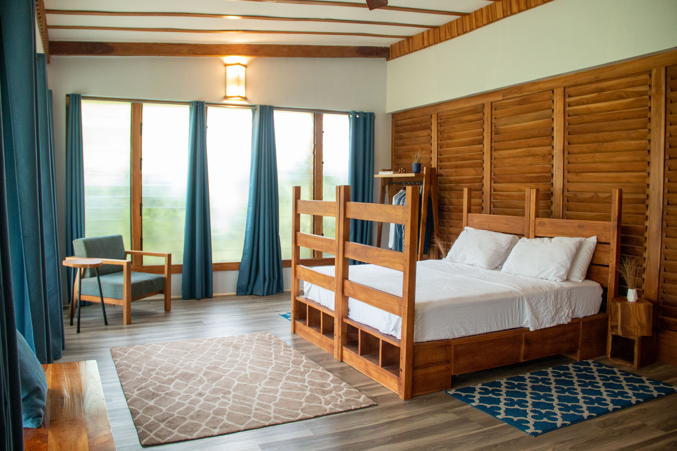 Sage Centre bedroom showing full teak bed and room fitout