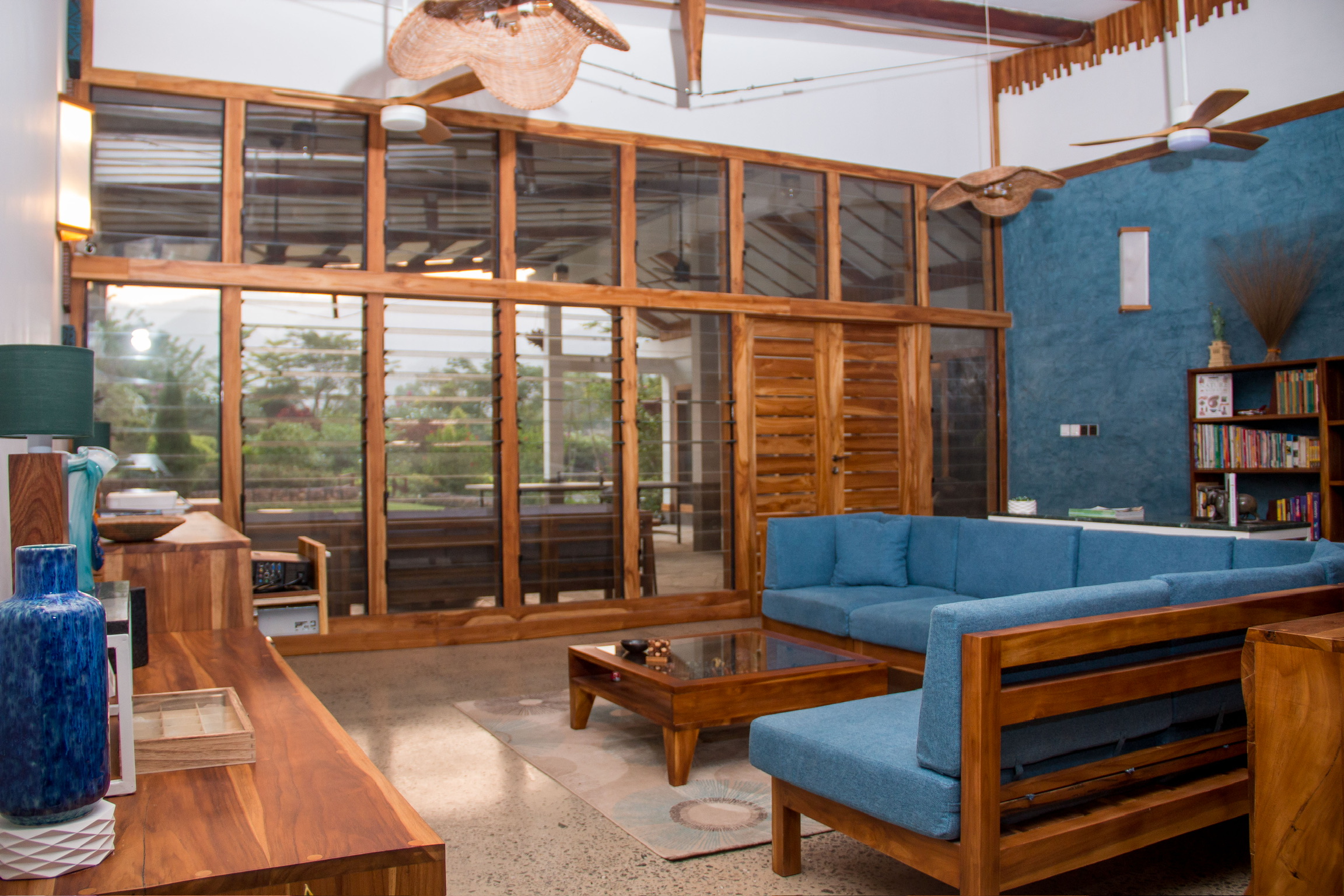 Teak sofa and sideboard in the main living space at Sage Centre, Wli Ghana