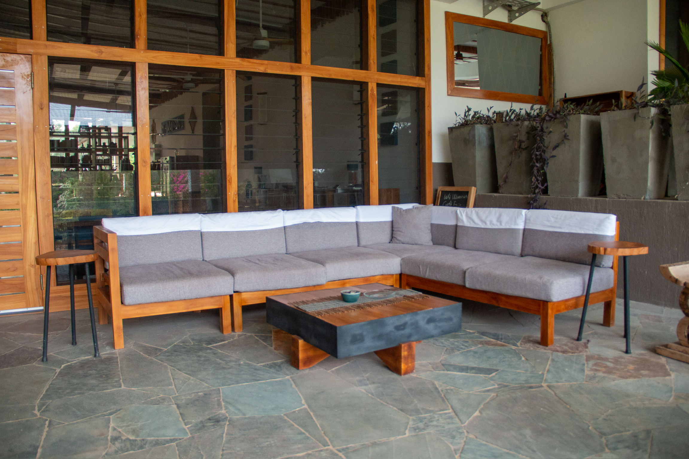 Outdoor L-shaped teak sofa set at Sage Centre terrace