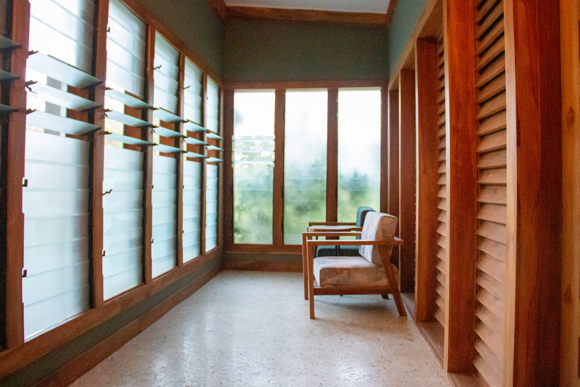 Teak louvre corridor with armchairs at Sage Centre