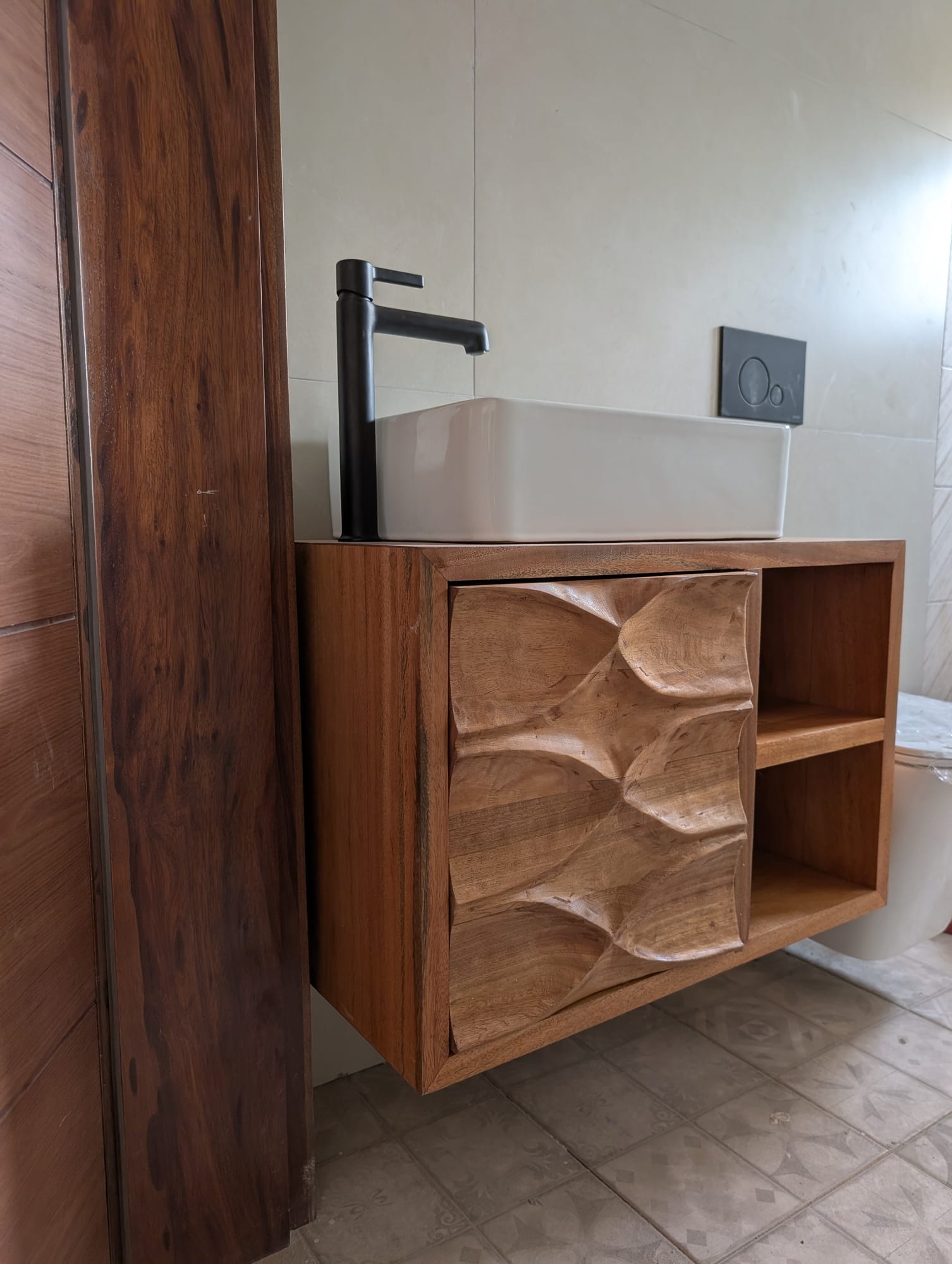 Khaya / African mahogany double-sink bathroom vanity with carved doors — Spintex estate, Accra, built by Neewoody Custom Woodwork